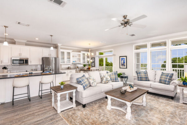 this photo displays the openness of this floor plan, showing the living room, dining room and kitchen.